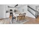 Charming dining area adjacent to the kitchen, featuring hardwood floors and access to the stairway at 9724 Brooks Dr, Fishers, IN 46055