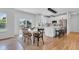 Eat-in kitchen dining area with modern light fixture, hardwood floors, and sliding door access to backyard at 9724 Brooks Dr, Fishers, IN 46055