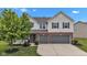 Beautiful exterior featuring a two-story home with a two-car garage and well-manicured lawn at 9724 Brooks Dr, Fishers, IN 46055
