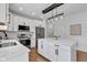 Beautiful kitchen with stainless steel appliances, hardwood floors, and large center island at 9724 Brooks Dr, Fishers, IN 46055