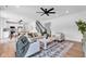 Open-concept living room featuring hardwood floors, neutral tones, and a seamless flow to the kitchen at 9724 Brooks Dr, Fishers, IN 46055