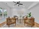 Cozy living room with four chairs, a modern ceiling fan, and ample natural light at 9724 Brooks Dr, Fishers, IN 46055