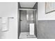 Bathroom walk-in shower featuring gray tiling, and glass doors with a white towel at 9724 Brooks Dr, Fishers, IN 46055