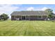 Large backyard with a well-manicured lawn and brick exterior of the home in the background at 1016 W Creek Ridge Dr, Fountaintown, IN 46130