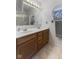 Bathroom featuring a double sink vanity, large mirror, and linen closet at 1016 W Creek Ridge Dr, Fountaintown, IN 46130