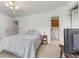 Bedroom with neutral carpeting, simple decor, and access to an ensuite bathroom at 1016 W Creek Ridge Dr, Fountaintown, IN 46130
