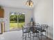 Bright dining area featuring a glass top table and views of the backyard pond at 1016 W Creek Ridge Dr, Fountaintown, IN 46130
