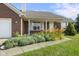 Charming red brick home with lovely landscaping and a well-maintained lawn at 1016 W Creek Ridge Dr, Fountaintown, IN 46130