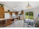Bright and airy kitchen with an island cooktop, white appliances, and a dining area with glass doors at 1016 W Creek Ridge Dr, Fountaintown, IN 46130