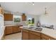 Well-lit kitchen features a cooktop island, lots of cabinet space, and a window overlooking the yard at 1016 W Creek Ridge Dr, Fountaintown, IN 46130