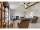 Cozy living room features vaulted ceilings, brick fireplace, ceiling fan, and comfortable seating at 1016 W Creek Ridge Dr, Fountaintown, IN 46130