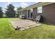 Brick patio with seating adjacent to the home and green lawn at 1016 W Creek Ridge Dr, Fountaintown, IN 46130