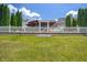 Expansive backyard with white fence and wooden gazebo, ideal for relaxation and recreation at 10758 Cyrus Dr, Indianapolis, IN 46231