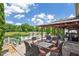 Outdoor patio with elegant seating and a serene view of a pond and lush greenery at 10758 Cyrus Dr, Indianapolis, IN 46231