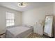 Comfortable bedroom with a neutral color scheme, a bed, and natural light from the window at 10758 Cyrus Dr, Indianapolis, IN 46231