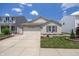Charming single-Gathering home with a well-manicured lawn and attached two-car garage at 10758 Cyrus Dr, Indianapolis, IN 46231