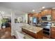 Open kitchen featuring stainless steel appliances and a granite island with seating, seamlessly connected to the living spaces at 10758 Cyrus Dr, Indianapolis, IN 46231