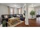 Inviting living room featuring a comfortable sectional sofa, stylish coffee table, and hardwood floors at 10758 Cyrus Dr, Indianapolis, IN 46231