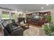 Cozy living room featuring a decorative fireplace, wooden built-ins and plush seating at 10758 Cyrus Dr, Indianapolis, IN 46231