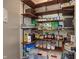 Walk-in pantry featuring organized shelves filled with various food items and storage containers at 10758 Cyrus Dr, Indianapolis, IN 46231