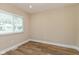 This bedroom features wood floors, a window with blinds, and a fresh coat of paint at 1122 W 35Th St, Indianapolis, IN 46208