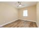 This bedroom features wood floors, a ceiling fan, and a fresh coat of paint at 1122 W 35Th St, Indianapolis, IN 46208