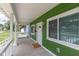 Covered front porch features durable flooring, fresh paint, updated lighting, and a street view at 1122 W 35Th St, Indianapolis, IN 46208