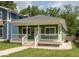 Charming bungalow with a green exterior, white trim, a front porch, and a well-manicured lawn at 1122 W 35Th St, Indianapolis, IN 46208