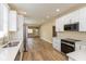 Modern kitchen with stainless steel appliances, updated cabinetry, new counters, and vinyl flooring at 1122 W 35Th St, Indianapolis, IN 46208