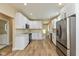 Kitchen featuring new cabinets, countertops, stainless steel appliances, and modern flooring at 1122 W 35Th St, Indianapolis, IN 46208