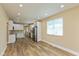 Open floor plan showcasing new flooring, updated kitchen with stainless appliances, and fresh paint at 1122 W 35Th St, Indianapolis, IN 46208