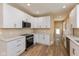 Remodeled kitchen boasts white cabinets, updated countertops, recessed lighting, and stainless appliances at 1122 W 35Th St, Indianapolis, IN 46208