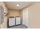 Bright laundry room featuring a new washer and dryer with epoxy floor and a storage shelf at 1122 W 35Th St, Indianapolis, IN 46208