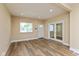 This living room features updated flooring, recessed lights, fresh paint and a view of the front porch at 1122 W 35Th St, Indianapolis, IN 46208