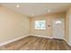 Bright living room with new floors, fresh paint, and large window provides natural light at 1122 W 35Th St, Indianapolis, IN 46208