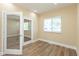 The light-filled office features wood floors and glass paneled french doors at 1122 W 35Th St, Indianapolis, IN 46208