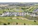 An aerial view displays homes nestled in a community with a golf course and ponds at 1165 Maclaren Ct, Franklin, IN 46131