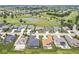 An aerial view showcases homes in a community with a golf course and ponds at 1165 Maclaren Ct, Franklin, IN 46131