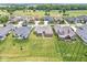An aerial view showcases lovely homes with green lawns, backing to a golf course at 1165 Maclaren Ct, Franklin, IN 46131