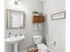 Cozy bathroom with pedestal sink, decorative mirror, toilet, and rustic decor at 1165 Maclaren Ct, Franklin, IN 46131