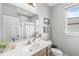 Bright bathroom featuring a vanity, mirror, and window with natural light at 1165 Maclaren Ct, Franklin, IN 46131