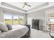 Relaxing bedroom with tray ceiling, scenic window view, and dark wood furniture at 1165 Maclaren Ct, Franklin, IN 46131