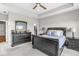 Comfortable bedroom with tray ceiling, a large bed, and dark wood furniture at 1165 Maclaren Ct, Franklin, IN 46131