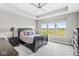 Spacious bedroom featuring a tray ceiling, large window with a view of a green field at 1165 Maclaren Ct, Franklin, IN 46131