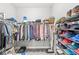 Organized walk-in closet with hanging clothes, shelves, and ample storage space at 1165 Maclaren Ct, Franklin, IN 46131