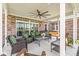 Covered patio with brick accents, ceiling fan, comfortable seating, and hot tub, creating an ideal outdoor relaxation space at 1165 Maclaren Ct, Franklin, IN 46131
