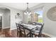 Charming dining room with a modern chandelier, a view of the backyard, and a rustic wooden table at 1165 Maclaren Ct, Franklin, IN 46131