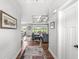 Inviting hallway with wood floors leads to an open living area with coffered ceilings and a view of the outdoors at 1165 Maclaren Ct, Franklin, IN 46131