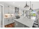 Bright kitchen with white cabinets, stainless steel appliances, large island and pendant lighting at 1165 Maclaren Ct, Franklin, IN 46131