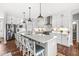 Modern kitchen featuring white cabinetry, stainless steel appliances, and a large island with bar seating at 1165 Maclaren Ct, Franklin, IN 46131